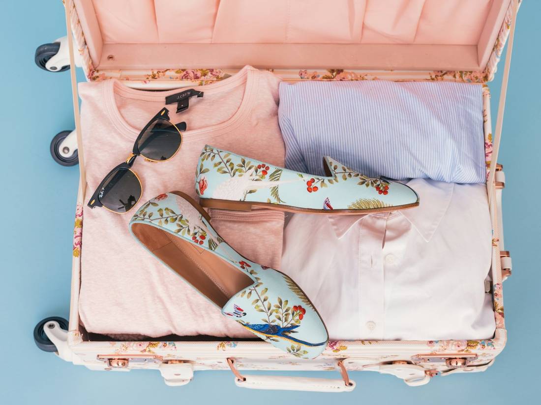 Clothes and shoes packed in luggage