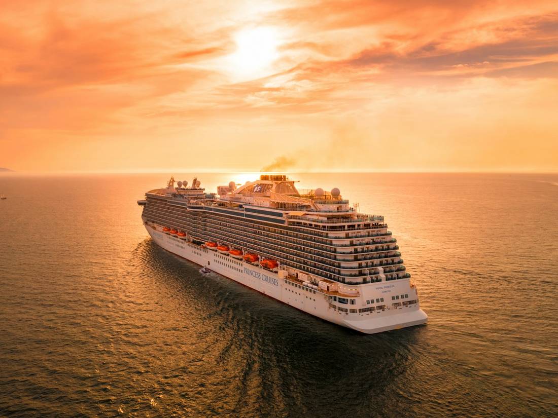 Cruise ship at sea at sunset