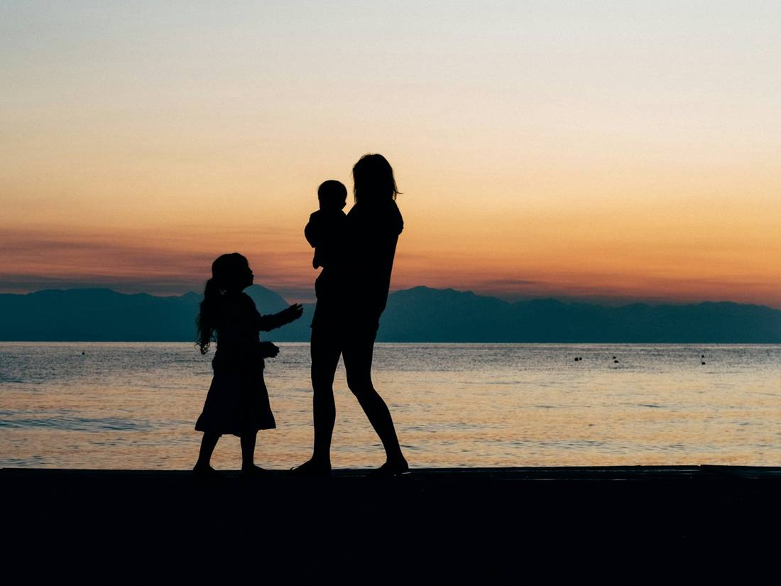 A mother and children at the shoreline