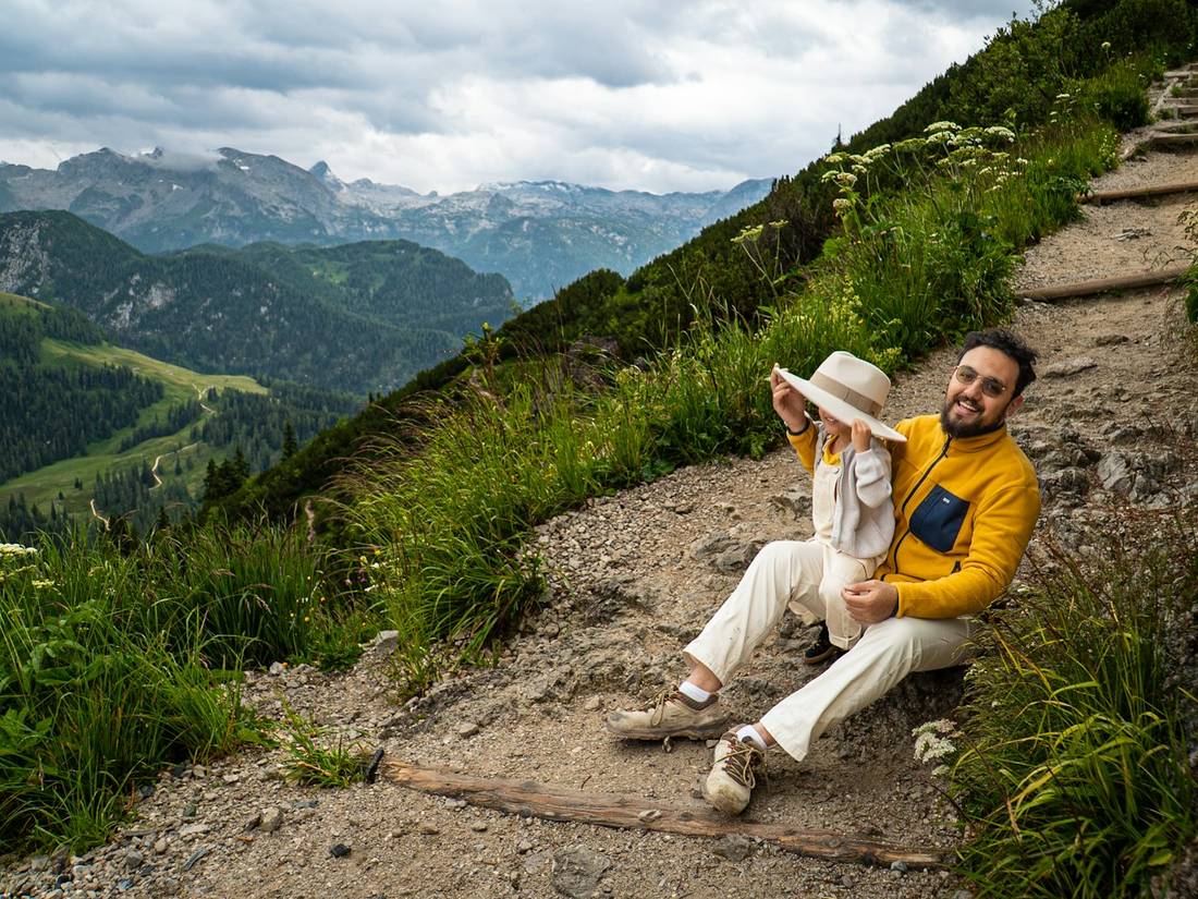A traveler resting on a mountain trail
