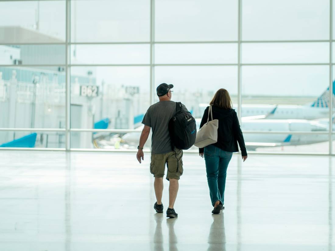 Travelers walking through an airport