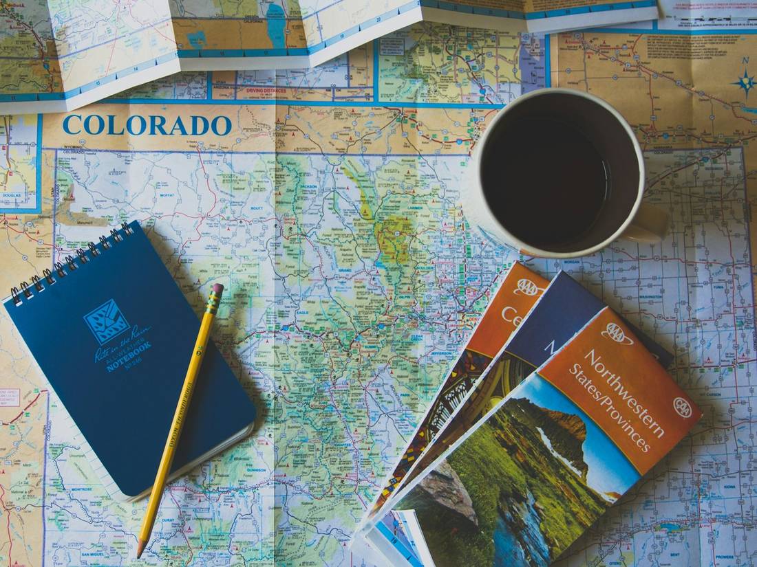 Books and a pencil on a map