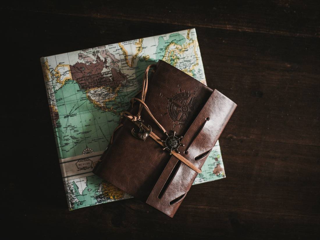 A leather travel journal on a map