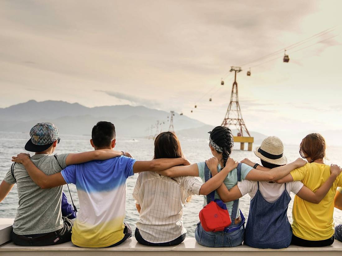Friends sitting together on a wall