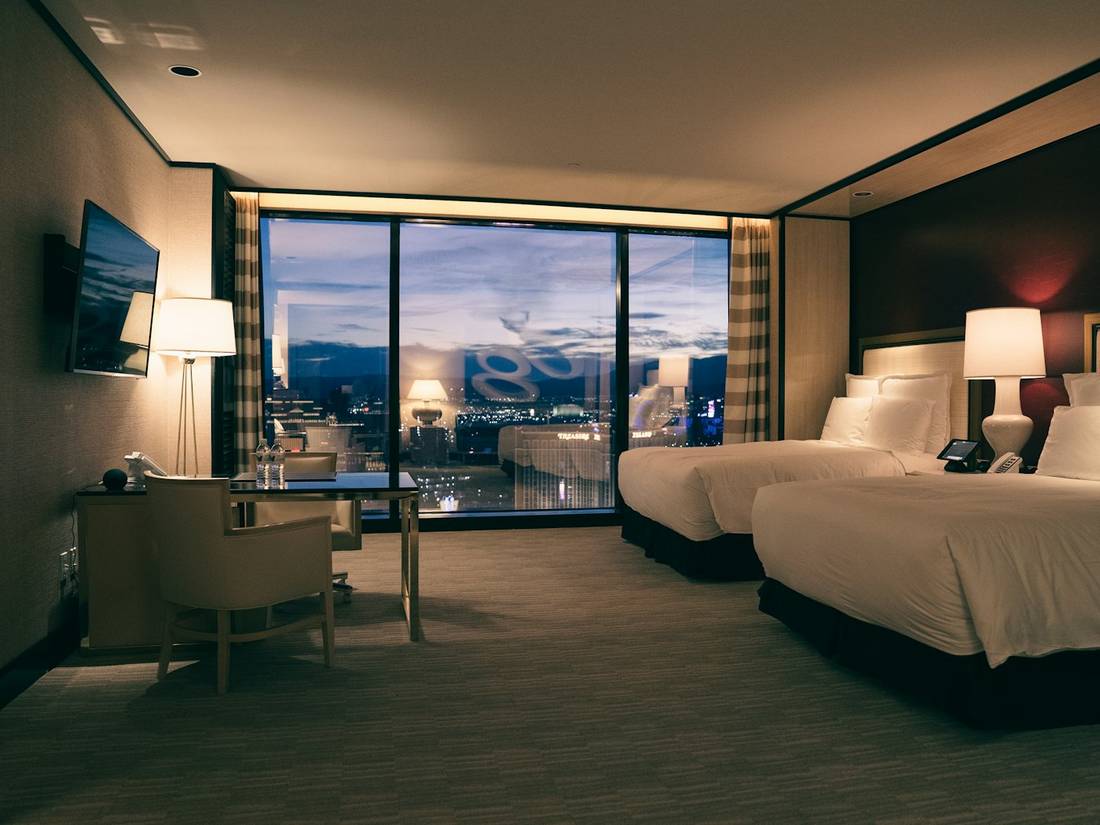 A hotel room with a city view